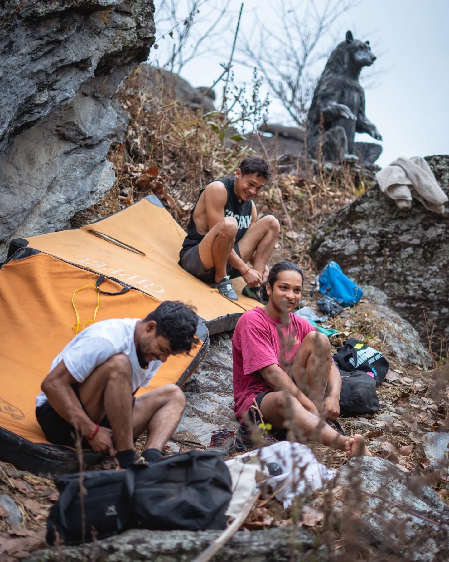 Climbers resting on crash pads