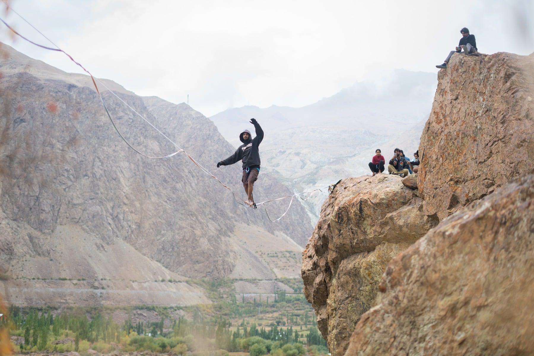 Highlining off a cliff above the valley